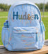 Personalized blue quilted kids backpack with custom name embroidery and side water bottle pocket outdoors