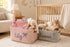 Personalized corduroy nursery storage baskets with custom names filled with baby clothes, toys, and essentials in a cozy nursery