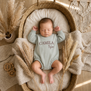 Baby romper with embroidered name detail close up