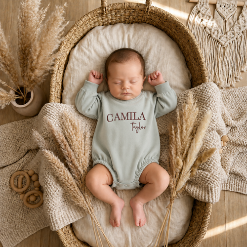 Baby romper with embroidered name detail close up